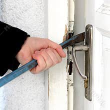 Burglar breaking into a house