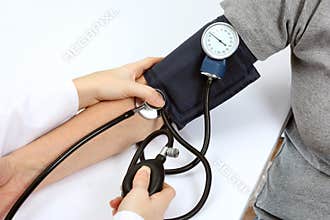 Doctor checking blood pressure with stethoscope