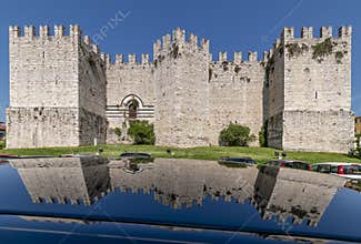 The ancient castle of the emperor of Prato, Italy, is reflected on the shiny surface of a car