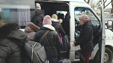 Lviv, Ukraine - March 15, 2022: Evacuation bus for refugees, escorted by pro-Russian rebels, which moves between