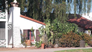 White mexican old house, window and garden, succulent cactus plant, California.