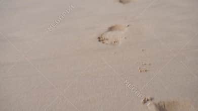 Barefoot footprint on sand ocean beach