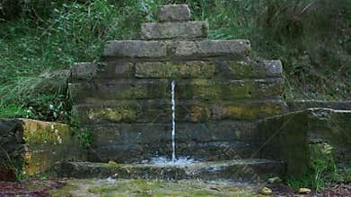 Beautiful small fountain in a slow motion.