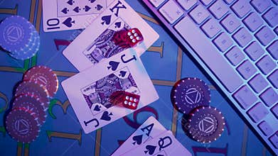 Top view of gaming table with computer keyboard, cards, dice and casino chips. Concept of gambling, online betting in