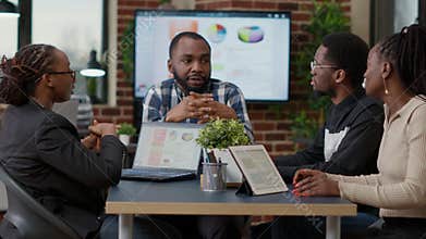 Team of african american businesspeople meeting in boardroom office