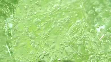 Green aloe vera cosmetic serum gel texture, transparent fluid, macro facial mask