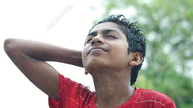 teenage boy under rain outdoor