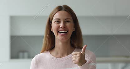 Headshot portrait happy woman looks at camera show thumbs up