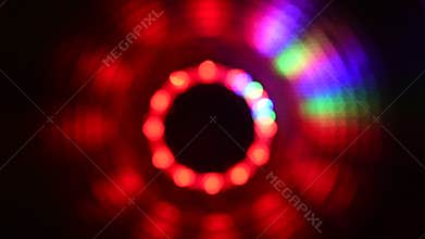 Blurry spinning red green blue lights against a black background
