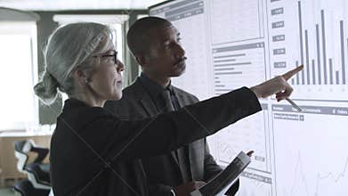 Diverse professionals discussing trading charts