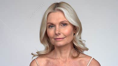 Confident beautiful 50s middle aged mature woman looking at camera.