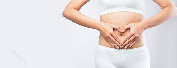 Close up woman hands made heart on belly isolated on white background banner size.health care digesting concept
