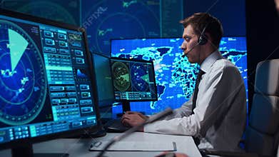 Workplace of the air traffic controllers in the control tower. Team of aircraft control officers works using radar