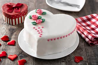 Heart cake for St. Valentine`s Day, Mother`s Day, or Birthday, decorated with roses and pink sugar hearts