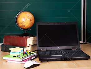 Books and laptop. School supplies.
