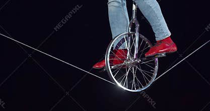 Close up of a man on a unicycle during a circus performance, 4k