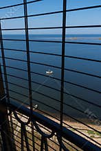 View to the Baltic sea and Sõrve peninsula through the protective grid  and railings from top of the Sõrve lighthouse