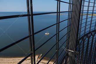 View to the Baltic sea and Sõrve peninsula through the protective grid  and railings from top of the Sõrve lighthouse