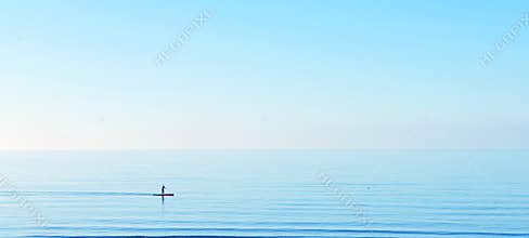 Peace tranquility serene serenity sup paddle boarding on a calm clear blue water ocean sea horizon copyspace