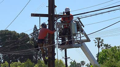 Linesmen Installing Telecom Lines Next to a Telephone Pole