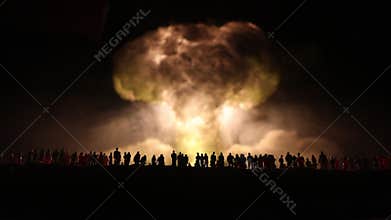 Nuclear war concept. Explosion of nuclear bomb. Creative artwork decoration in dark. Silhouette of soldier standing against giant