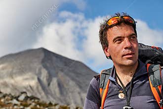 A happy man hiking in the mountains