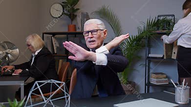 Senior businessman director showing stop gesture with crossed hands say no refuse in modern office