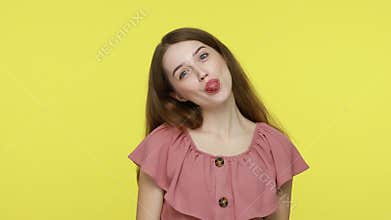 Girl with disobedient behavior, sticks out tongue at camera,