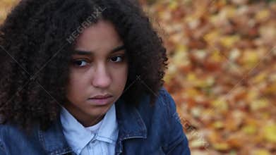 Mixed race African American girl looking sad depressed afraid or thoughtful