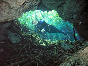 A Cavern Diver Poses in a Cenote Surface Opening