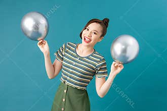 Beautiful woman holding balloons with happy expression on background