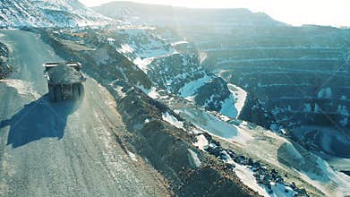 Truck with copper ore is riding along the open-pit mine