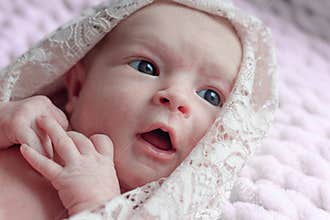 Gaze of a newborn in a pink blanket