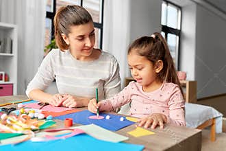 daughter with mother making applique at home