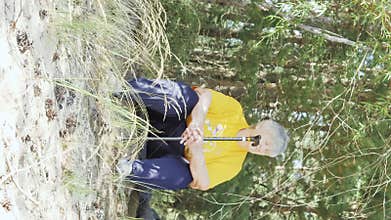 The old lady with the walking stick infront of her. vertical format video.9:16