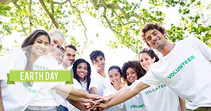 Animation of earth day text and globe logo over happy eco volunteers under tree making hand stack