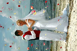 Beach wedding throwing flowers