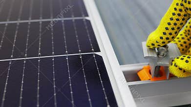 Mounting solar panel, installing solar panels on the roof of the house. Connection of solar panels. Close up of worker