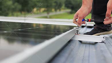 Mounting solar panel, installing solar panels on the roof of the house. Connection of solar panels. Close up of worker