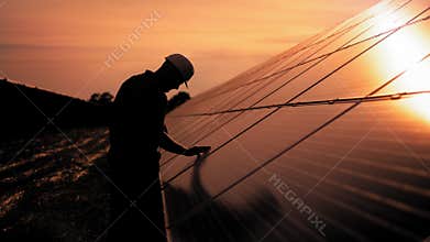 Assistance technical worker in uniform is checking an operation and efficiency performance of photovoltaic solar panels
