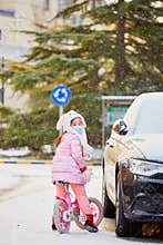 Girl with bicycle getting on car in snow, travel plan and carry-on.