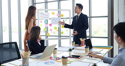 Happy business people meeting present graph chart investment, business data in meeting room. Group of business people meeting in c