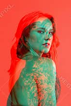 Conceptual image with young adorable woman and silhouette of dog isolated over red background with glitch effect, split