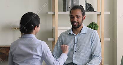Diverse deaf people sit indoor communicating with sign language