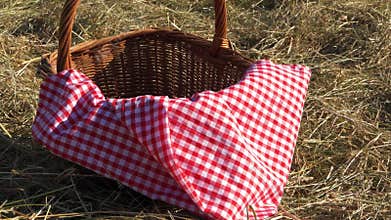 Vintage picnic basket and red gingham blanket shot in rural field