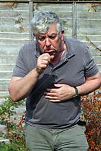 Elderly man coughing. smoking.