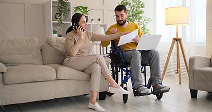Disabled man celebrating success with wife on receiving good news using mobile phone