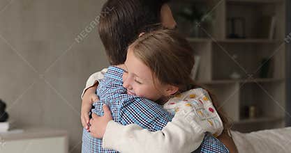 Loving preteen adopted daughter embrace neck of caring foster dad