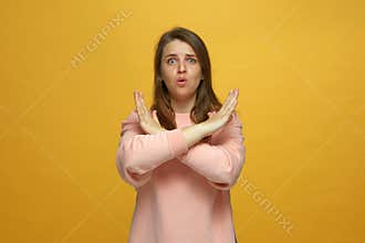 Fearful young girl crossed her hands in stop gesture saying no, ask to finish, end something, declining communication