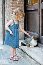 Adorable happy little girl and a cat